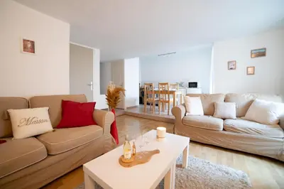 a living room with two couches and a table at L'évasion de Bedoin, appartement in Bédoin