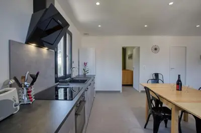 a kitchen with a counter top and a table at Appartement neuf Bédoin - Les Cinglés du Mont Ventoux in Mormoiron