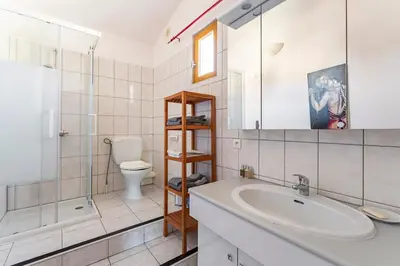 a bathroom with a sink and a toilet and a mirror at Charmant T2 2/4 Personnes in Pernes-les-Fontaines