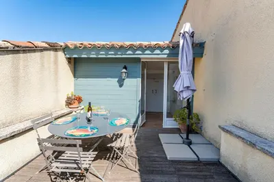a table and chairs with an umbrella on a patio at Charmant T2 2/4 Personnes in Pernes-les-Fontaines