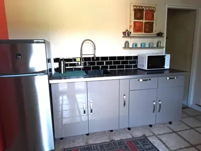 a kitchen with a sink and a refrigerator at Appartement en campagne au coeur du luberon in Roussillon