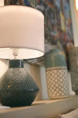 a lamp sitting on a shelf next to two vases at Le mas de Roussillon in Roussillon