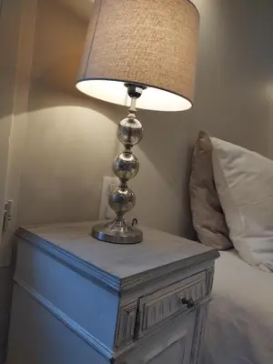 a lamp on a table next to a bed at Le mas de Roussillon in Roussillon