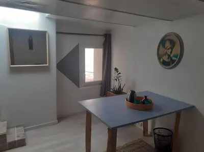 a living room with a table and a window at Maison restaurée à l'ancienne avec terrasse in Jouques
