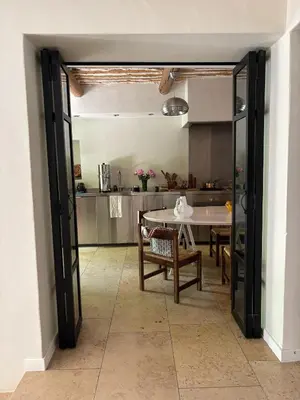 a kitchen with a table and a dining room at Le Clos de Gordes in Gordes