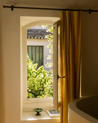 an open window with a vase on a window sill at Le Clos de Gordes in Gordes