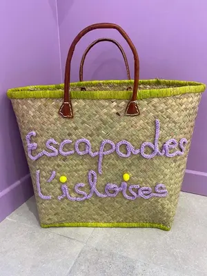 a basket with a sign that says exporax excellence at Escapades L'Isloises au cœur de L'Isle-sur-la-Sorgue. in LʼIsle-sur-la-Sorgue