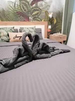 a blanket is laying on a bed at Escapades L'Isloises au cœur de L'Isle-sur-la-Sorgue. in LʼIsle-sur-la-Sorgue