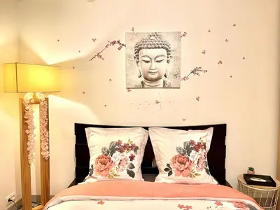 a bedroom with a bed with a picture of a buddha at *Le Lotus*Fiber Wifi*Hyper Center* in Salon-de-Provence