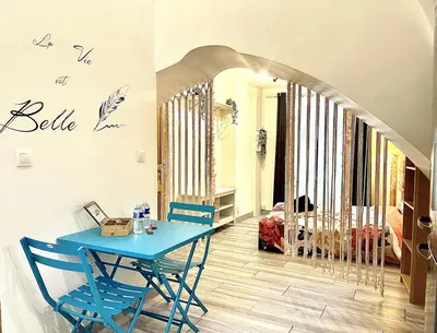 a dining room with a blue table and chairs at *Le Lotus*Fiber Wifi*Hyper Center* in Salon-de-Provence