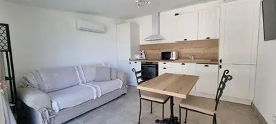 a living room with a couch and a table at LES BOIS DE ZOLA entre Provence et Luberon in Saint-Estève-Janson