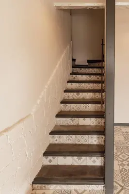 a set of stairs in a room with white walls at La ferme du 645 in Entraigues-sur-la-Sorgue