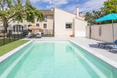 a swimming pool in the backyard of a house at Le Petit Mas Rey in Eyragues