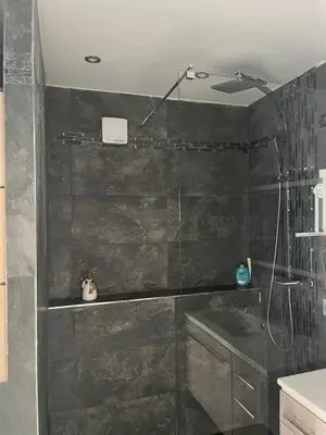 a black bathroom with a shower and a tub at House of Essia in Aix-en-Provence
