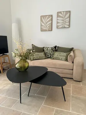 a living room with a couch and a table at Maison d’Oléa in Bonnieux