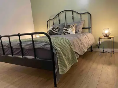 a black bed with pillows on it in a bedroom at Appartement design pour 6 pers dans le centre de Salon de Pce - Proche Fontaine Moussue in Salon-de-Provence