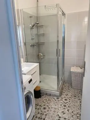 a bathroom with a shower and a washing machine at 