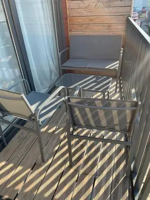 two chairs and a table on a balcony at 