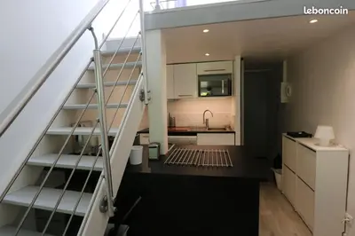 a staircase leading up to a kitchen in a house at Le Gassendi Duplex in Aix-en-Provence