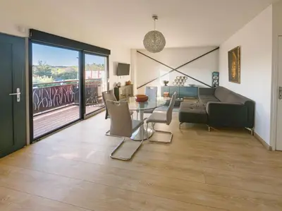 a living room with a couch and a table and chairs at 