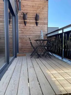 a patio with a table on a wooden deck at 