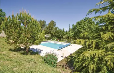 a swimming pool in the middle of a garden at Cozy Home In Apt With Wifi in Apt