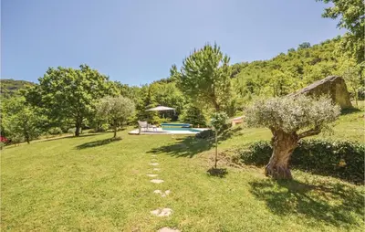 a garden with a tree and a swimming pool at Cozy Home In Apt With Wifi in Apt