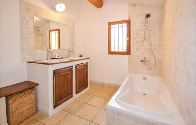 a bathroom with a tub and a sink and a bath tub at Cozy Home In Apt With Wifi in Apt