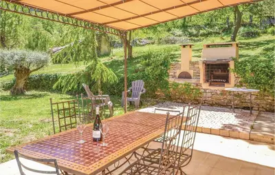 a patio with a table and chairs and a fireplace at Cozy Home In Apt With Wifi in Apt
