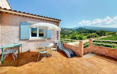 a patio with a table and chairs and a window at 3 Bedroom Stunning Home In Bédoin in Bédoin
