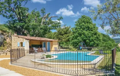a villa with a pool and a playground at Amazing Home In Sainte Croix-À-Lauze in Sainte-Croix-à-Lauze