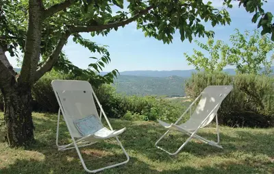 two chairs sitting in the grass under a tree at Amazing Home In Sainte Croix-À-Lauze in Sainte-Croix-à-Lauze
