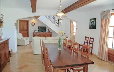 a dining room and living room with a table and chairs at Amazing Home In Sainte Croix-À-Lauze in Sainte-Croix-à-Lauze