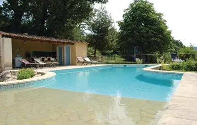 a swimming pool in a yard with chairs and a playground at Amazing Home In Sainte Croix-À-Lauze in Sainte-Croix-à-Lauze