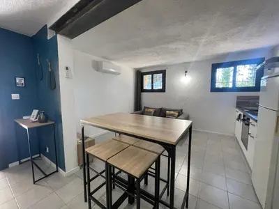 a kitchen with a table and chairs in a room at Oustau Aix - Maison Odonata in Aix-en-Provence