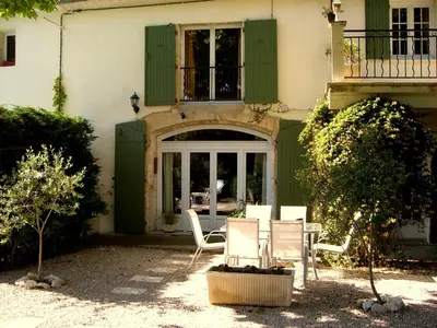 a table and chairs in front of a house at Mas de St-Andiol in Cabannes