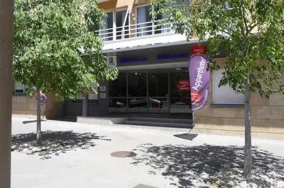 a store front of a building with trees in front at STUDIO Mr&Mrs in Aix-en-Provence