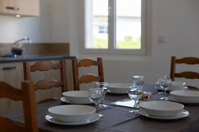 a table with plates and wine glasses on it at L Orchidée in Mormoiron