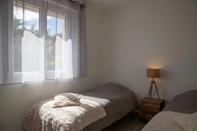 a bedroom with a bed and a window at L Orchidée in Mormoiron