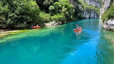 a group of people in kayaks on a river at Sud luberon in Ansouis