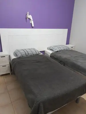 two beds sitting next to each other in a room at Sud luberon in Ansouis