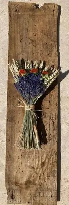 a bunch of flowers sitting on a wooden table at Au Nid de la Sorgue maison avec piscine chauffée 3 ch 6 personnes in LʼIsle-sur-la-Sorgue