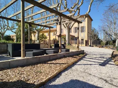 a pavilion with benches in front of a building at Havre de paix au sein d'un T3 d'une bastide aixoise in Aix-en-Provence