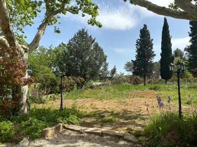 a garden with two lights in a field at Havre de paix au sein d'un T3 d'une bastide aixoise in Aix-en-Provence