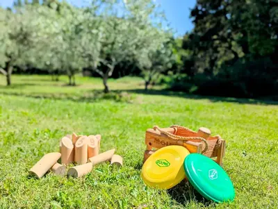 a frisbee and wooden shoes on the grass at L'Escargolette - Incroyable maison de vacances 4 étoiles in Carpentras