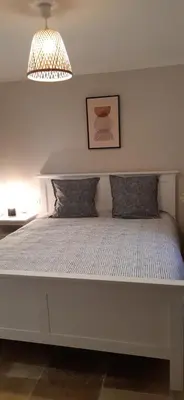 a large white bed with two pillows on it at Le gîte d'églantine in Eyguières