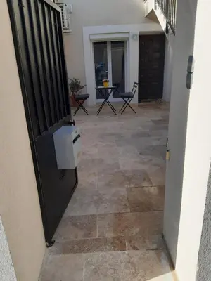 an open door to a patio with a table and chairs at Le gîte d'églantine in Eyguières
