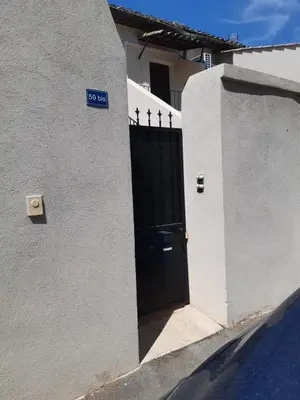 a door to a house with a sign on it at Le gîte d'églantine in Eyguières