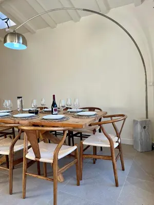 a dining room with a wooden table and chairs at La Maison Jaune, une expérience inoubliable in Villes-sur-Auzon