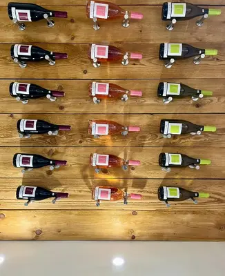 a bunch of wine bottles on a wooden table at La Maison Jaune, une expérience inoubliable in Villes-sur-Auzon